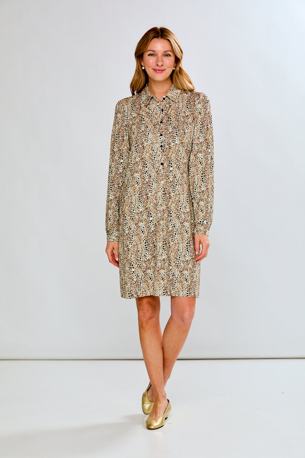 Woman wearing a patterned dress on a white background