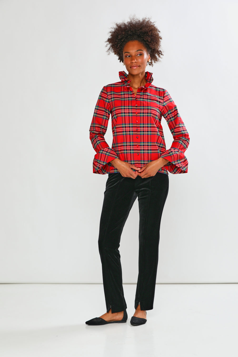 Person wearing a red plaid shirt on a white background