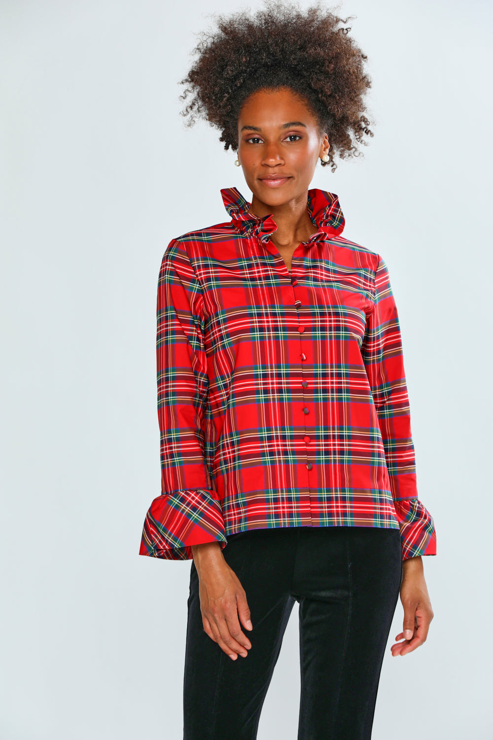 Person wearing a red plaid shirt on a white background