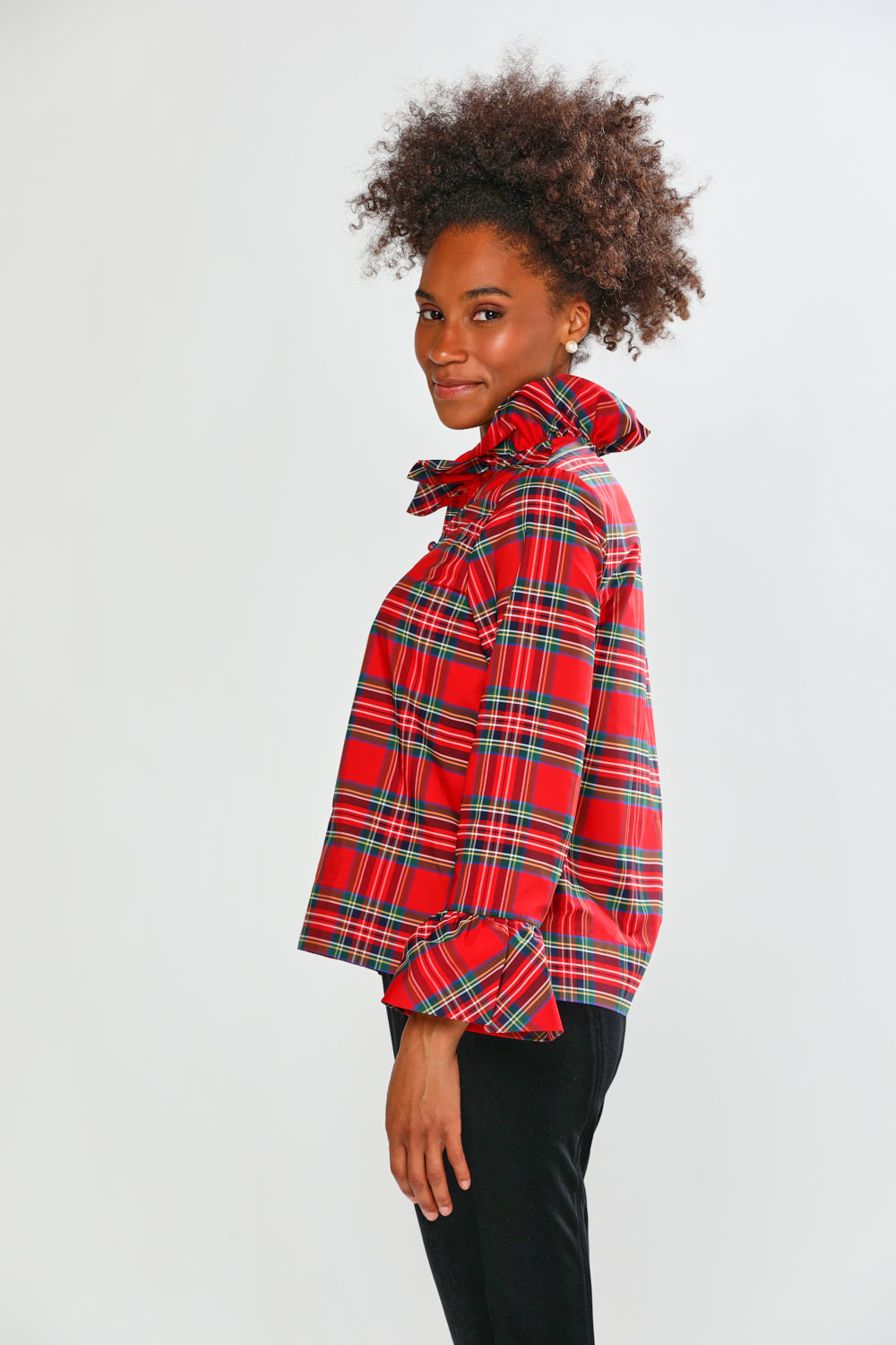 Person wearing a red plaid shirt on a white background