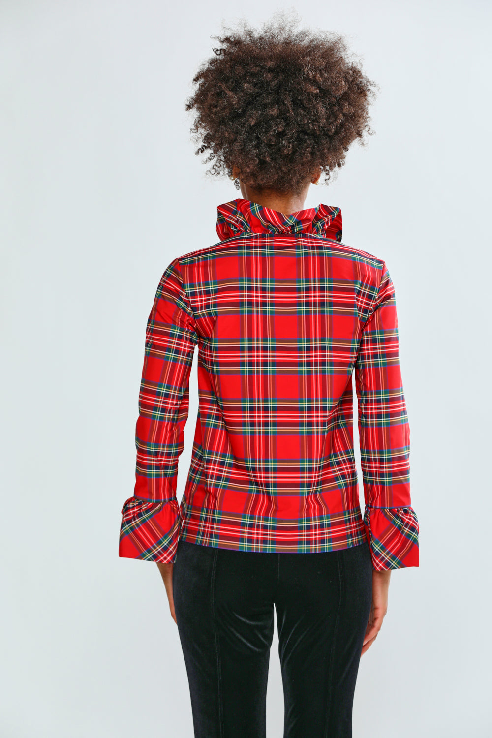 Person wearing a red plaid shirt on a white background