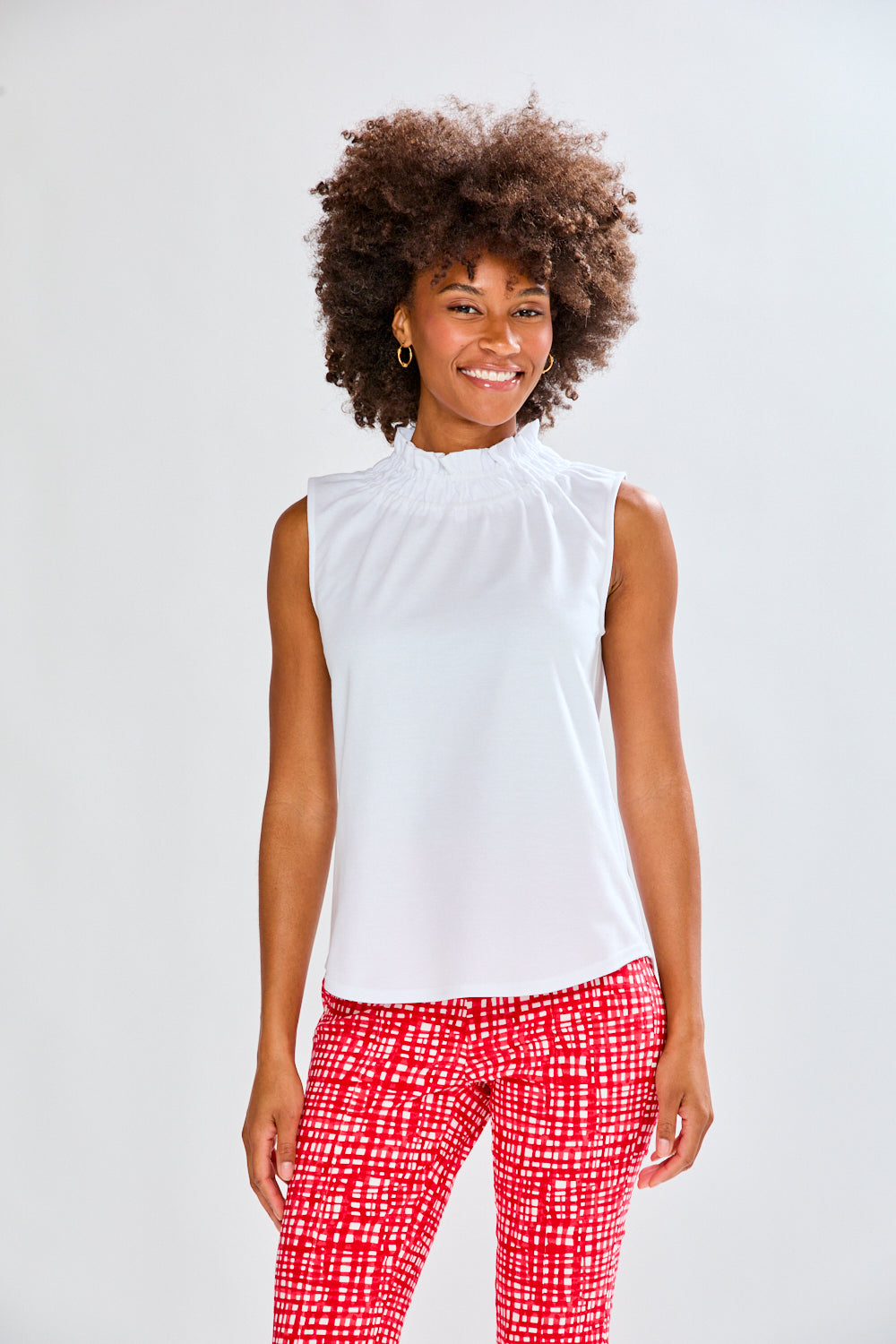 Woman in white top and patterned pants