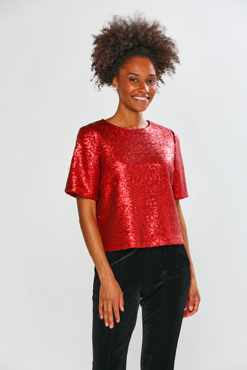 Woman in red blouse with black pants 