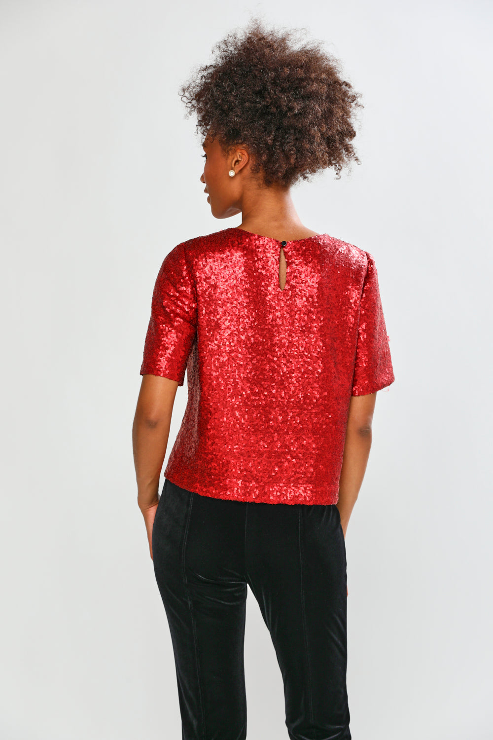 Woman in red blouse with black pants 