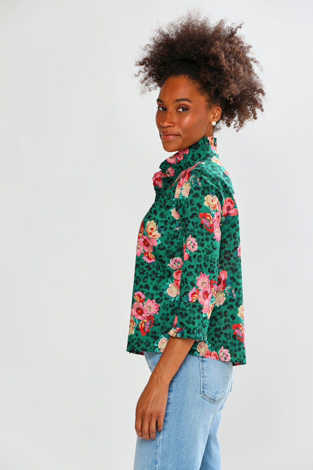 Woman wearing a green floral blouse on a white background