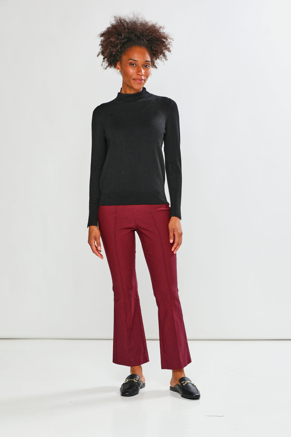 Maroon pants worn by a person on a white background
