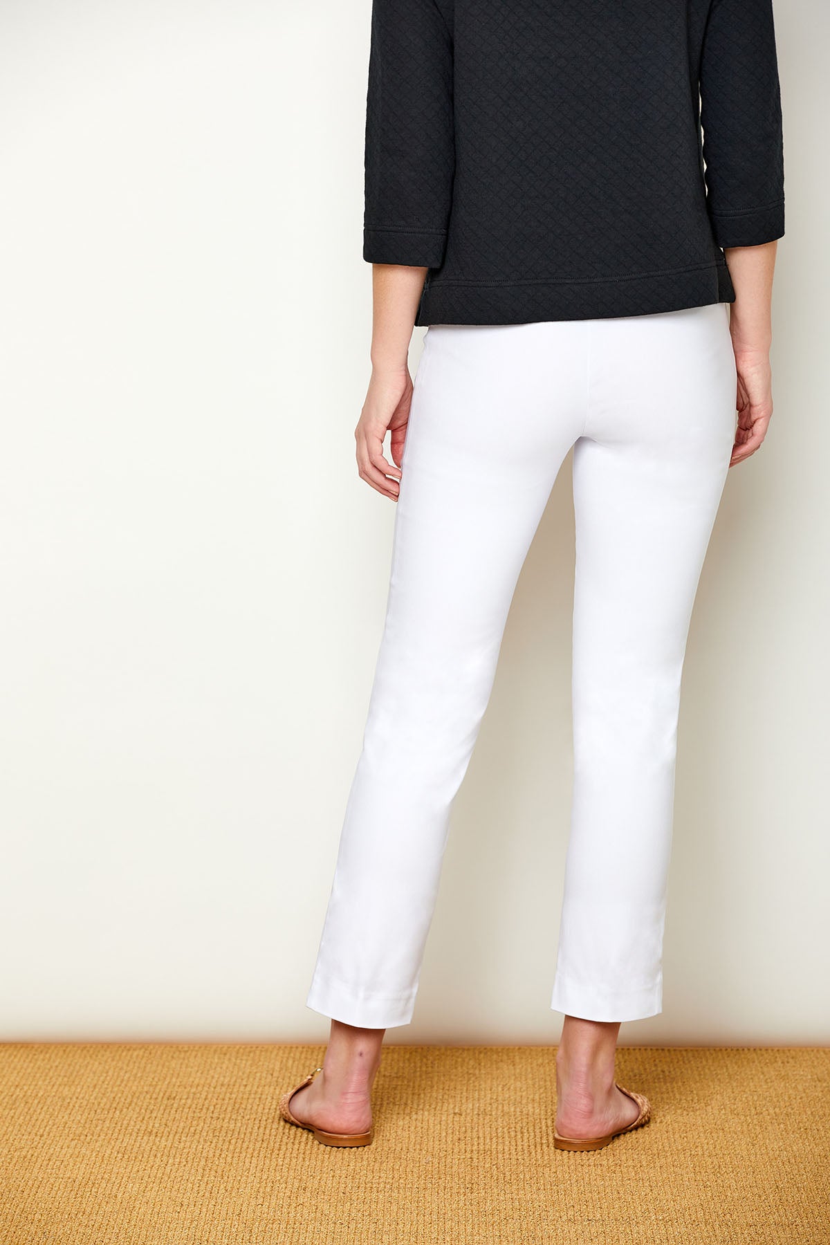 Woman in fitted white pants