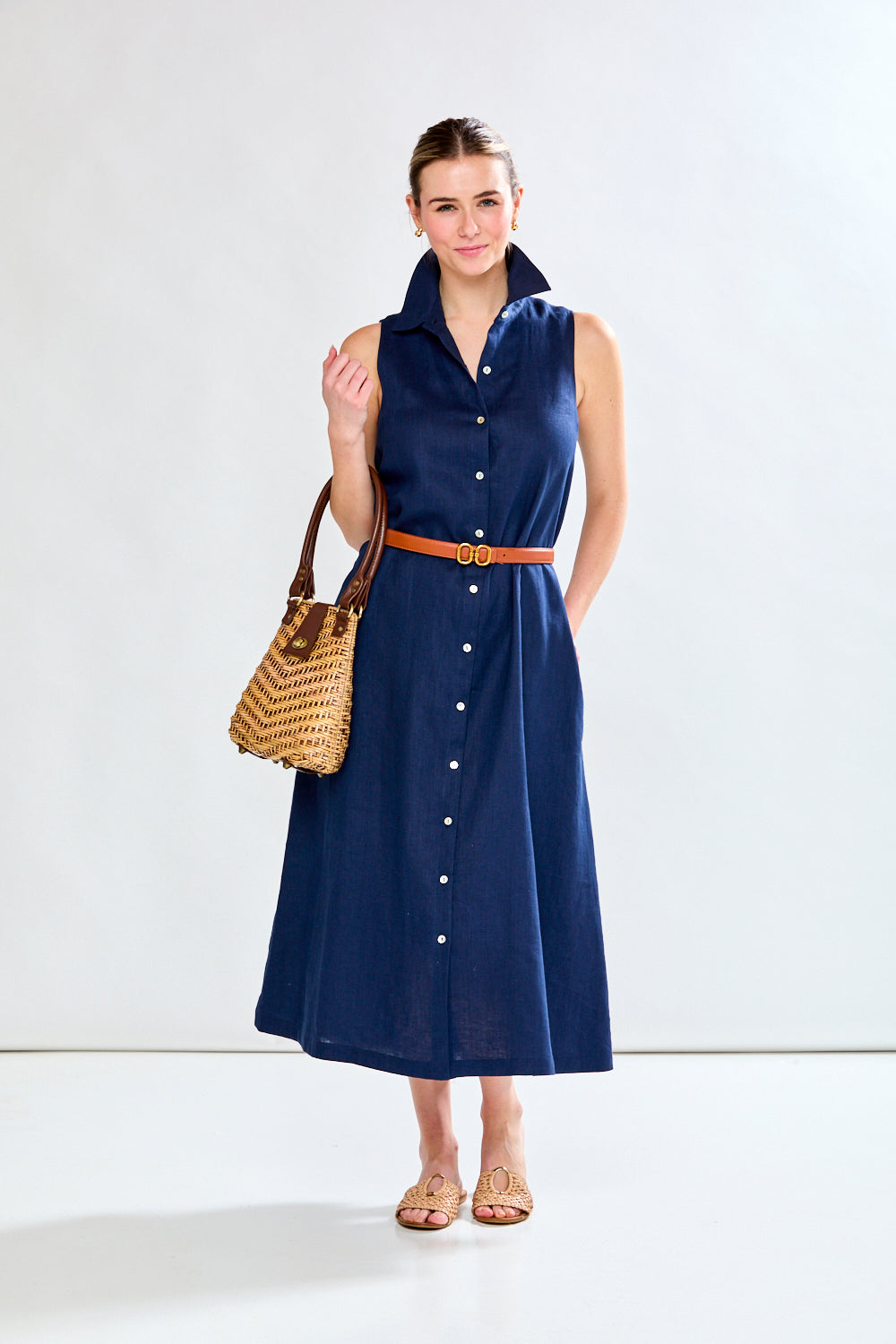 Woman in navy sleeveless dress