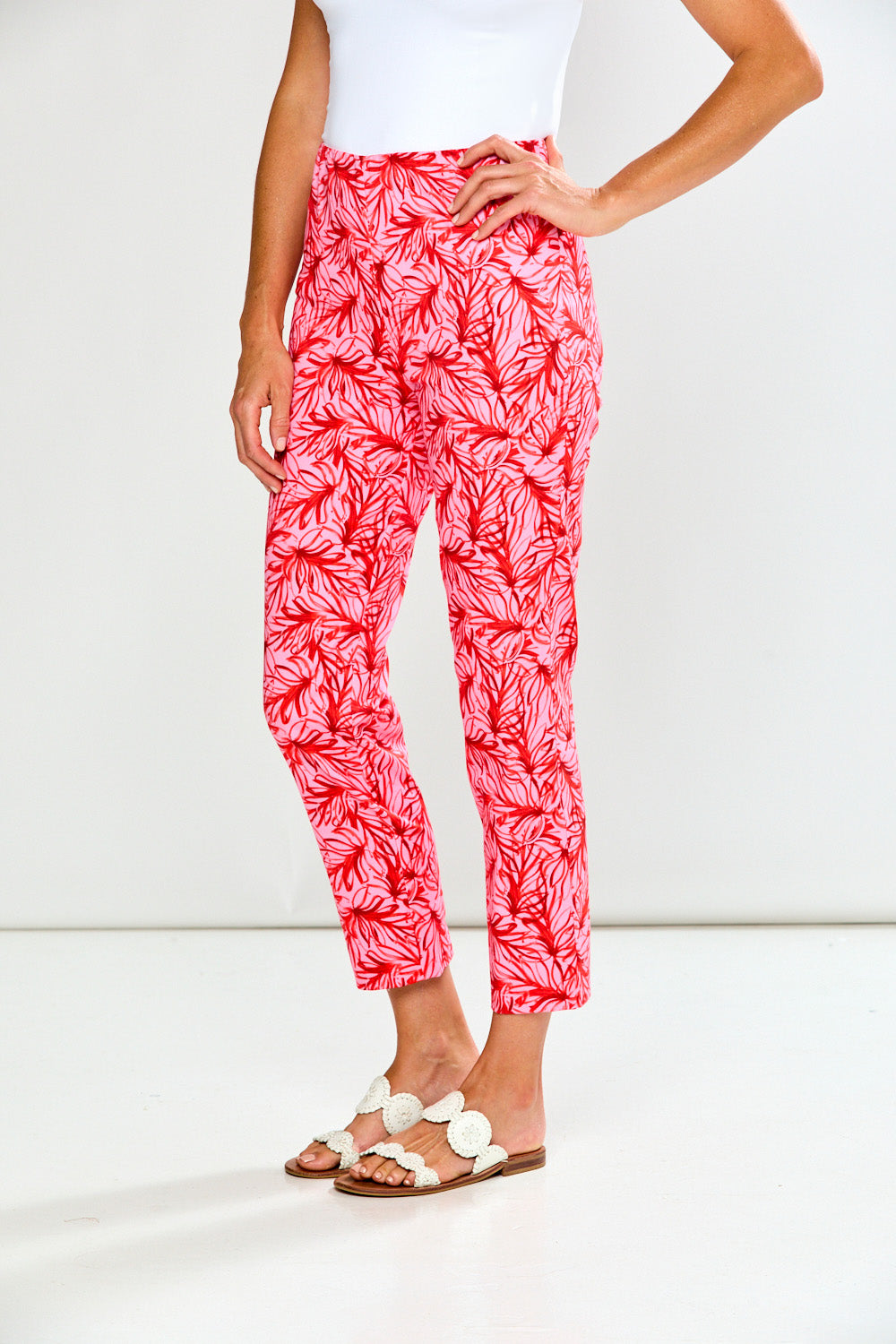 Person wearing red and white patterned pants on a white background