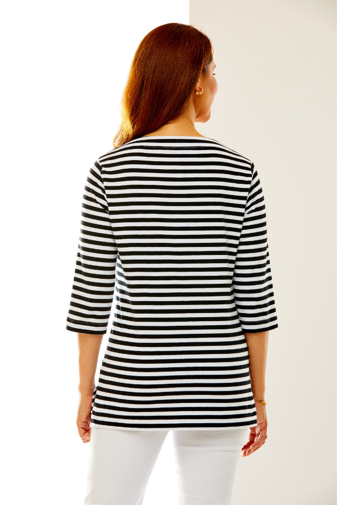Woman in black and white striped top