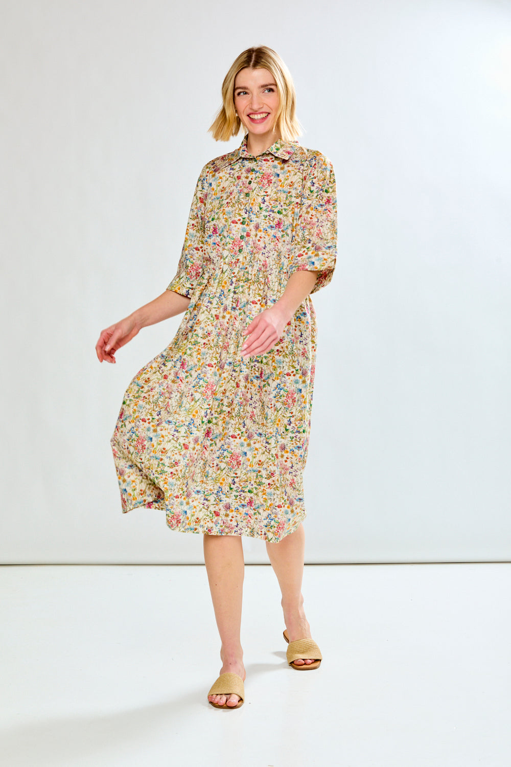 Woman wearing a floral dress on a white background