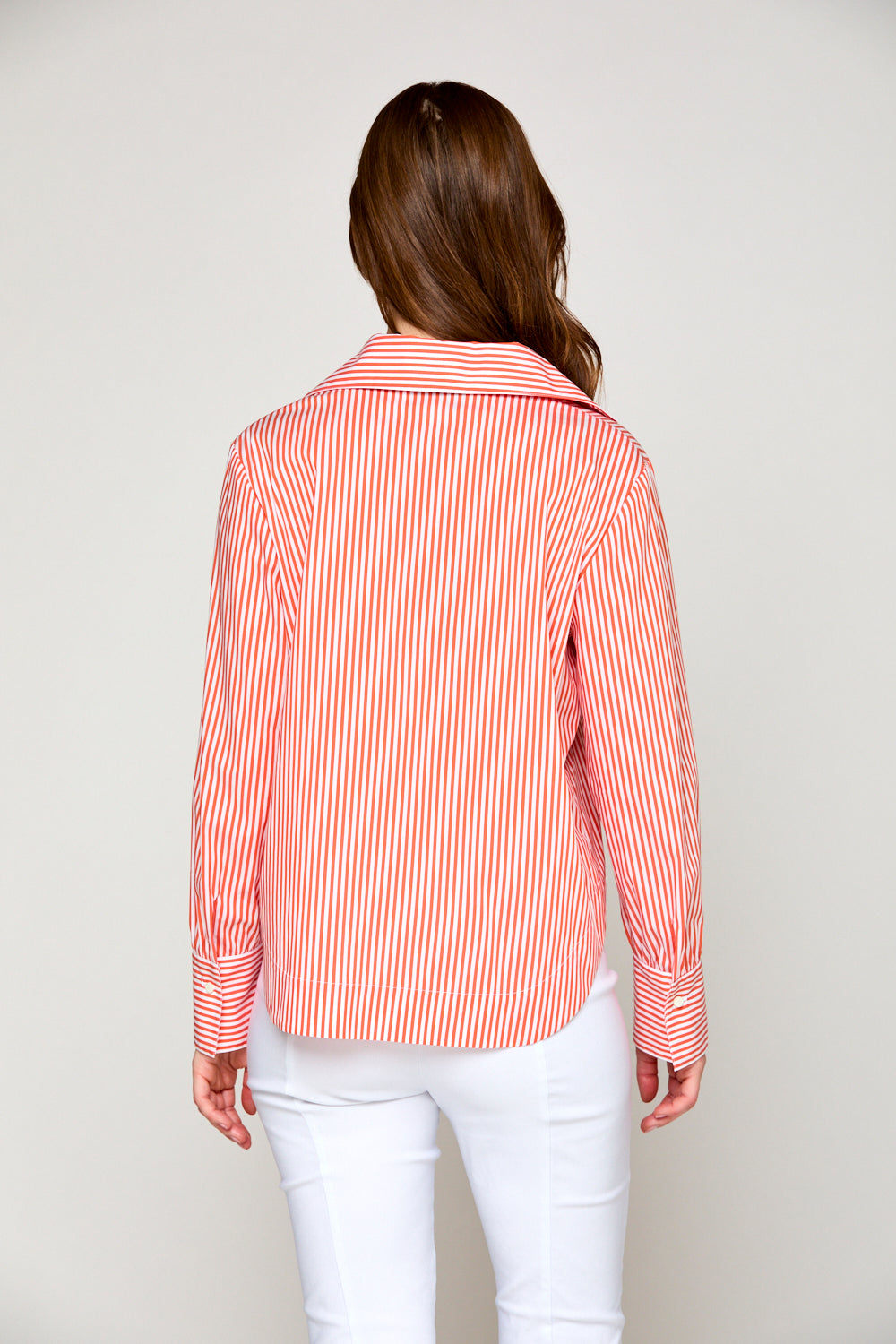 Woman in orange and white striped top