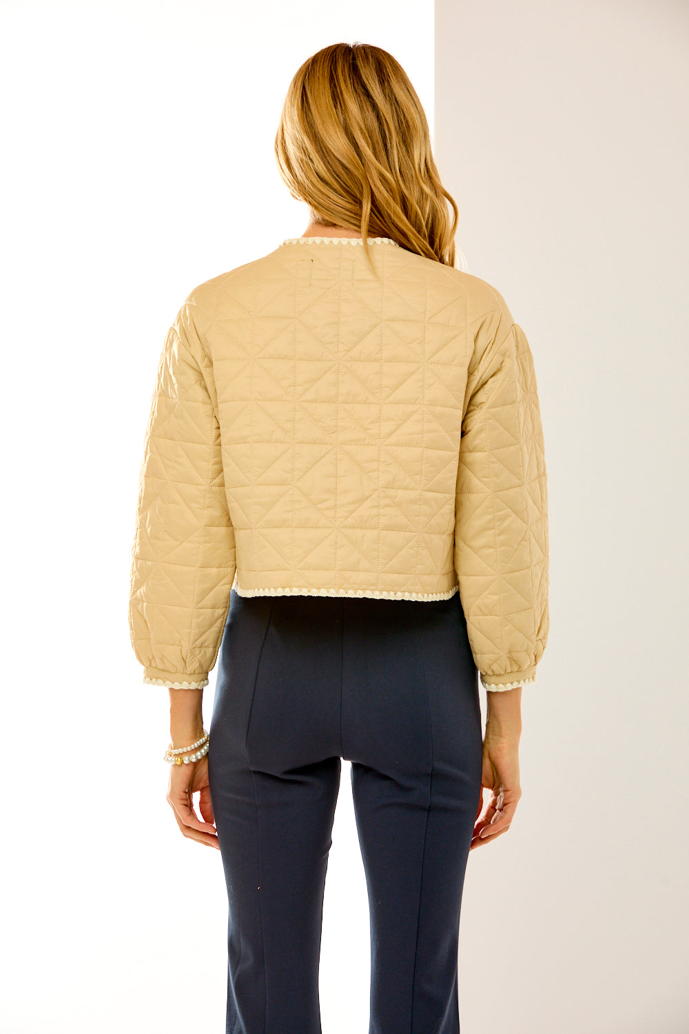 Woman in sand quilted jacket