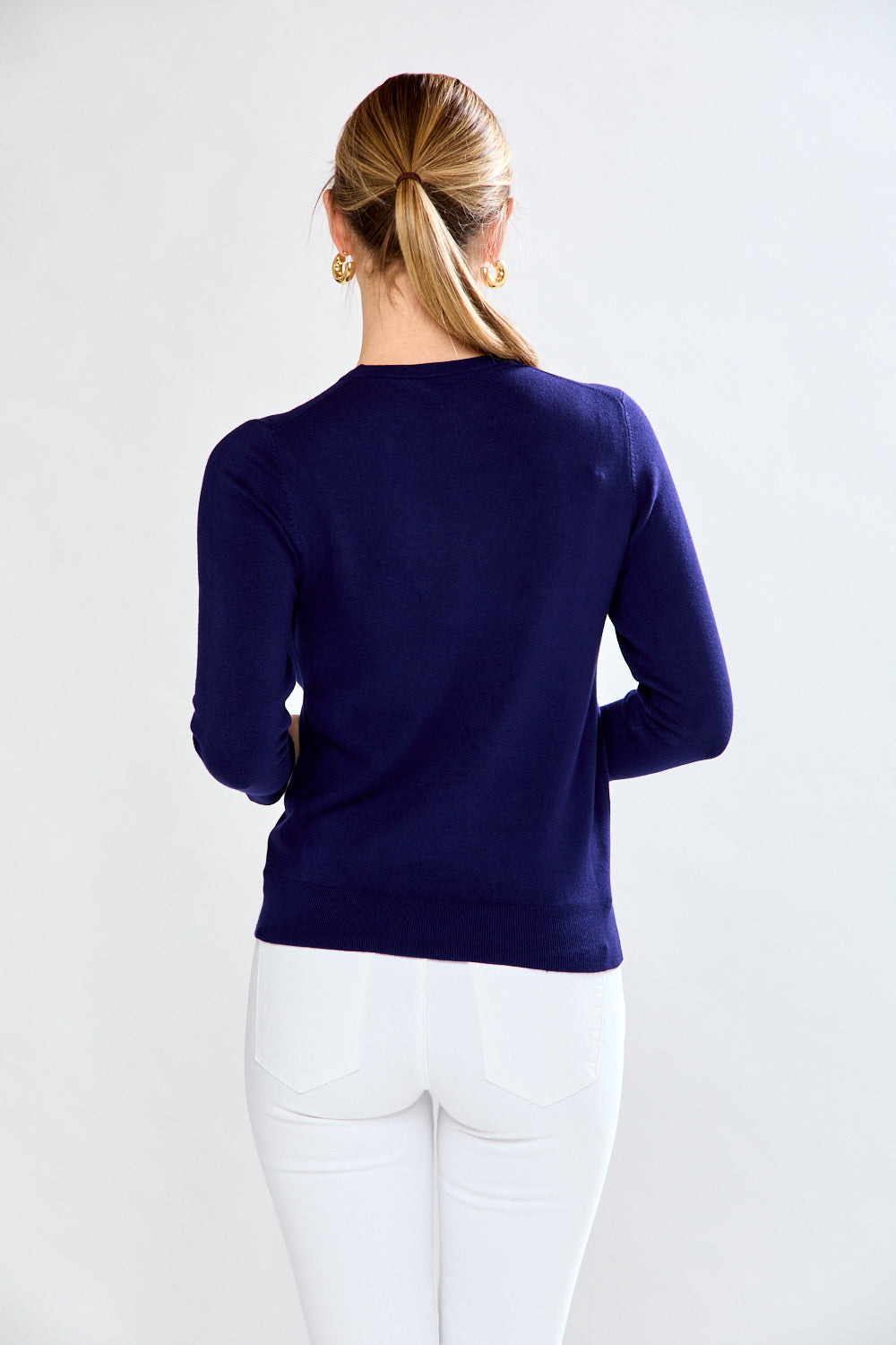 Woman in navy/white sweater