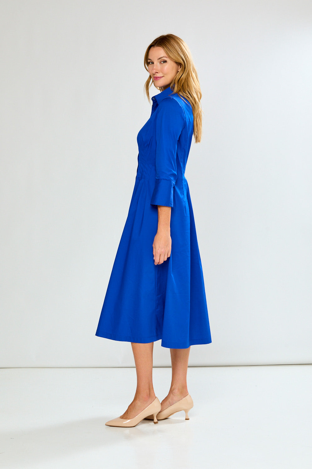 Woman wearing a blue dress against a white background