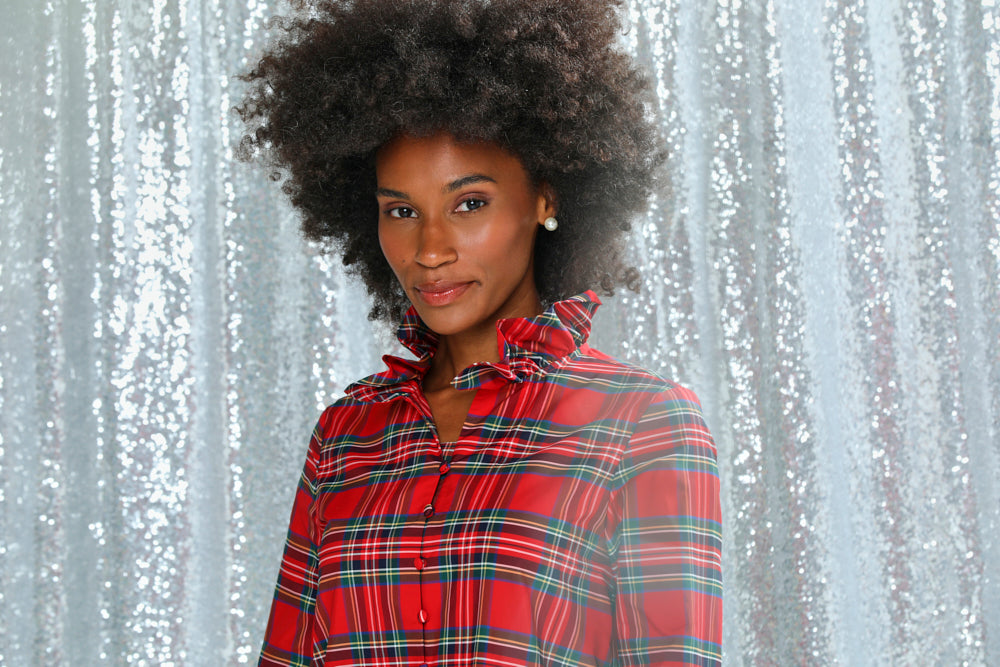 Person wearing a red plaid shirt on a white background