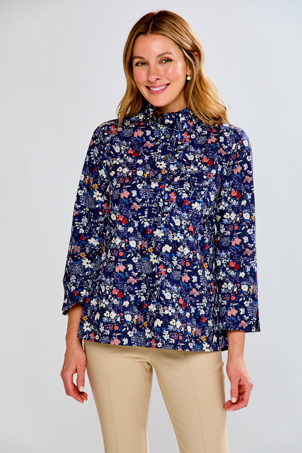 Woman wearing a floral blouse with a plain background