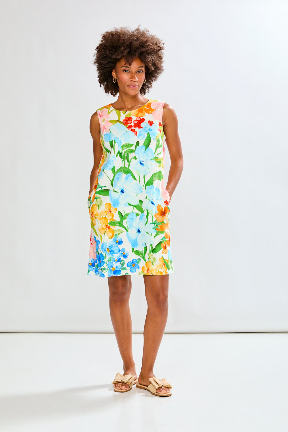 Woman wearing The Sleeveless Rue Dress in Tropical Blooms