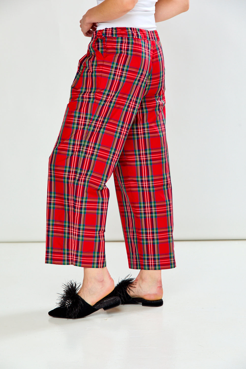 The Marcia Pant - Red Plaid shown from the back in a cropped wide leg silhouette with a classic red plaid pattern and tailored waistband