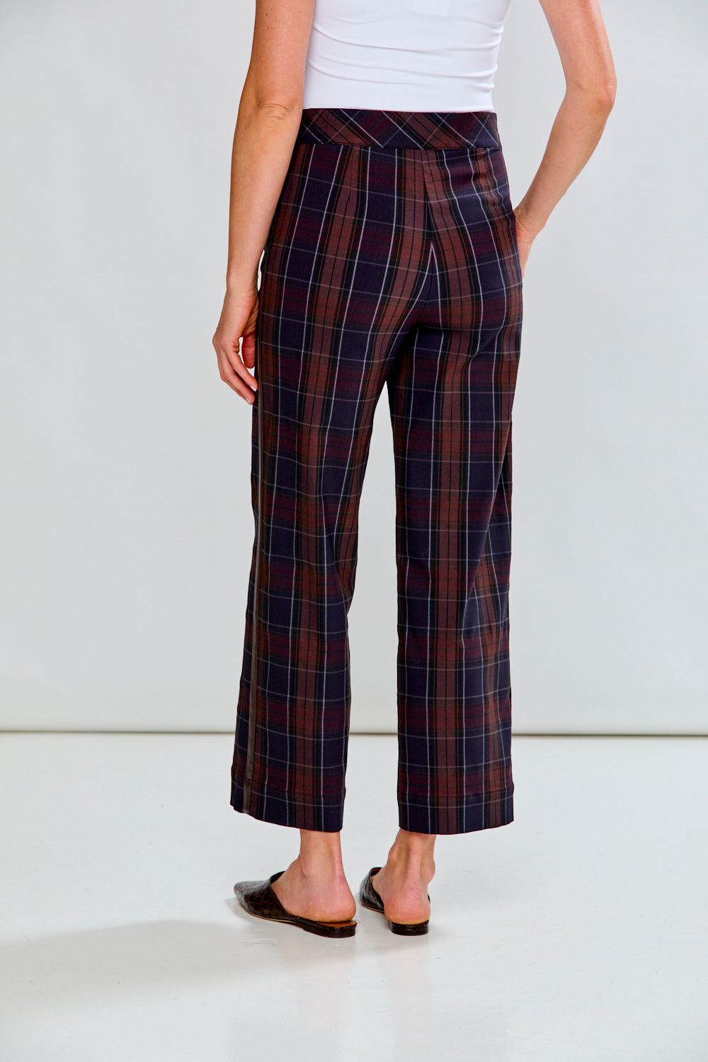 Person wearing plaid pants with a white background
