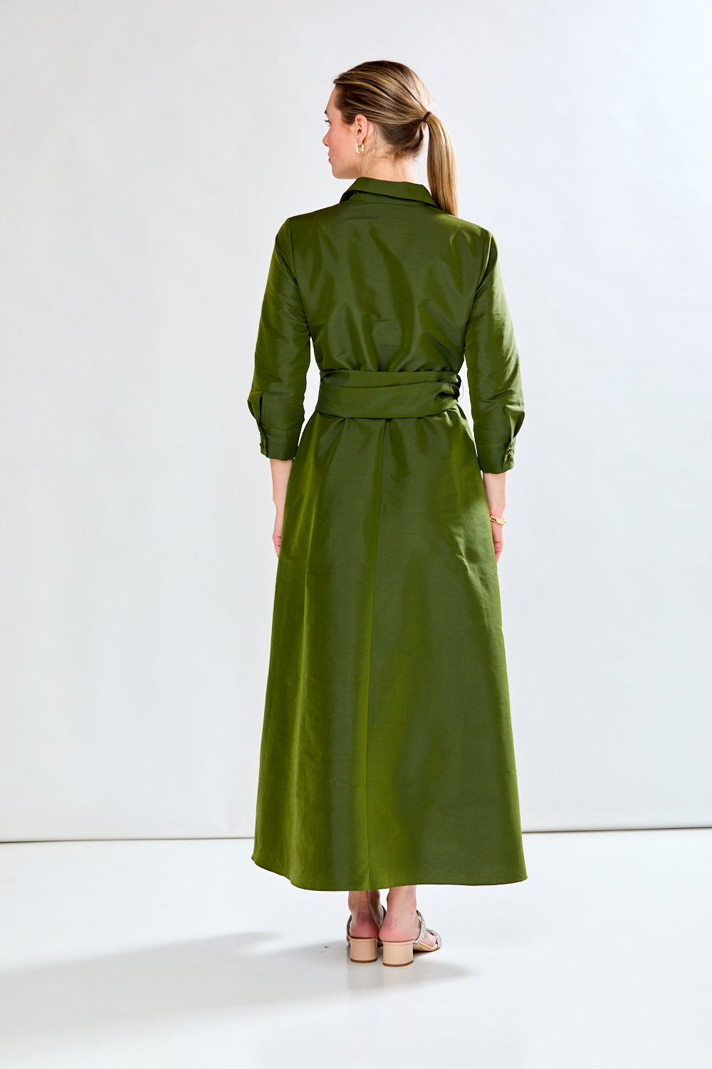 Woman in olive taffeta dress