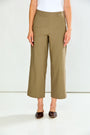 A model wearing a pair of mushroom cropped wide-leg trousers, paired with a white top and dark brown flat shoes, against a plain white studio background.