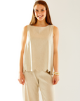 Woman in oatmeal top with scallop detail
