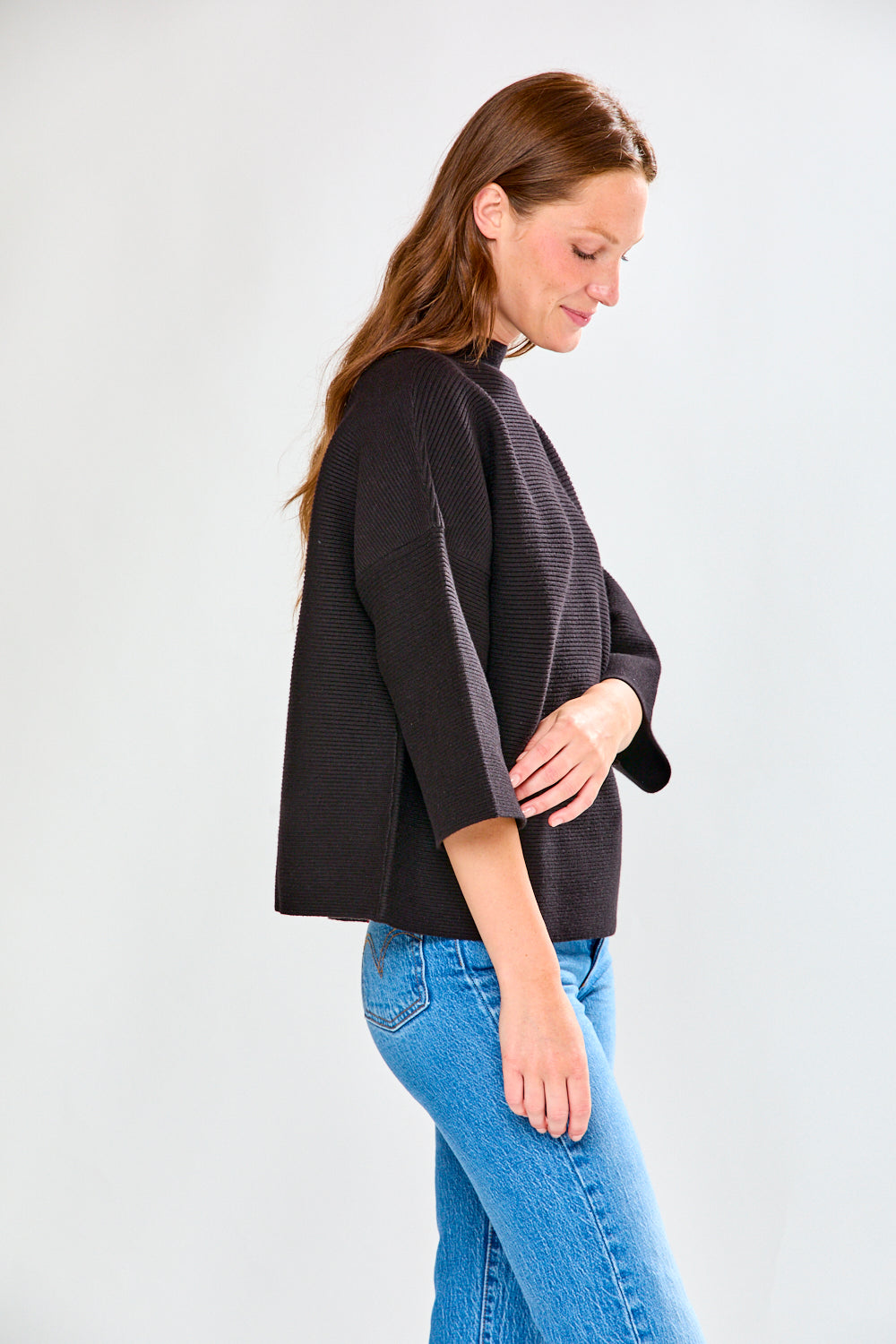 Woman in black ribbed sweater
