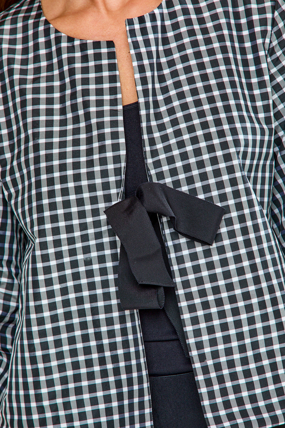 Black and white checkered jacket with a black tie detail