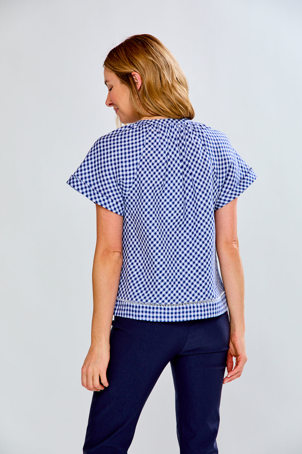 woman in navy gingham top