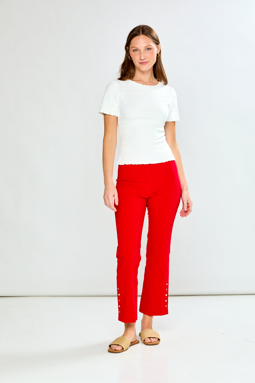 woman in white top and red pants