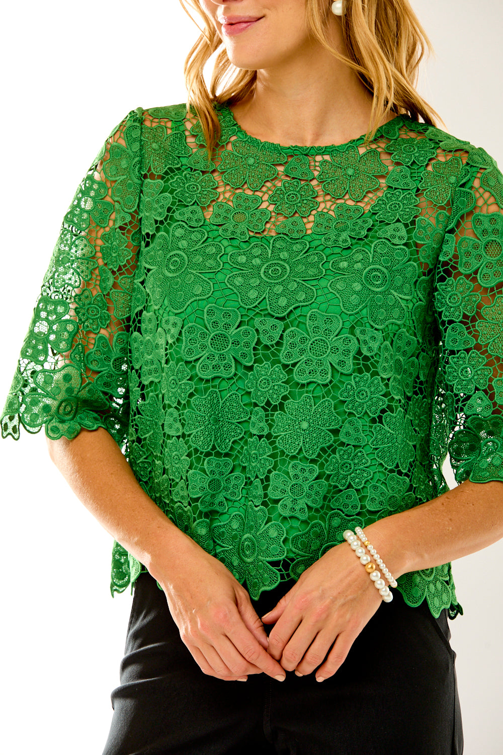 detail of woman in green lace top 