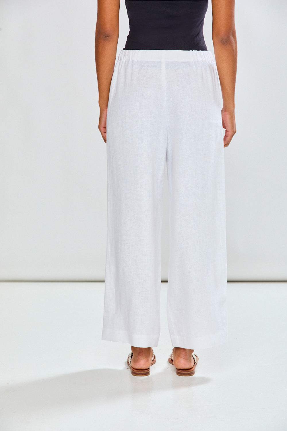 Woman in white linen pants