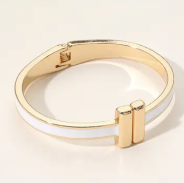 Gold bracelet on a light beige background