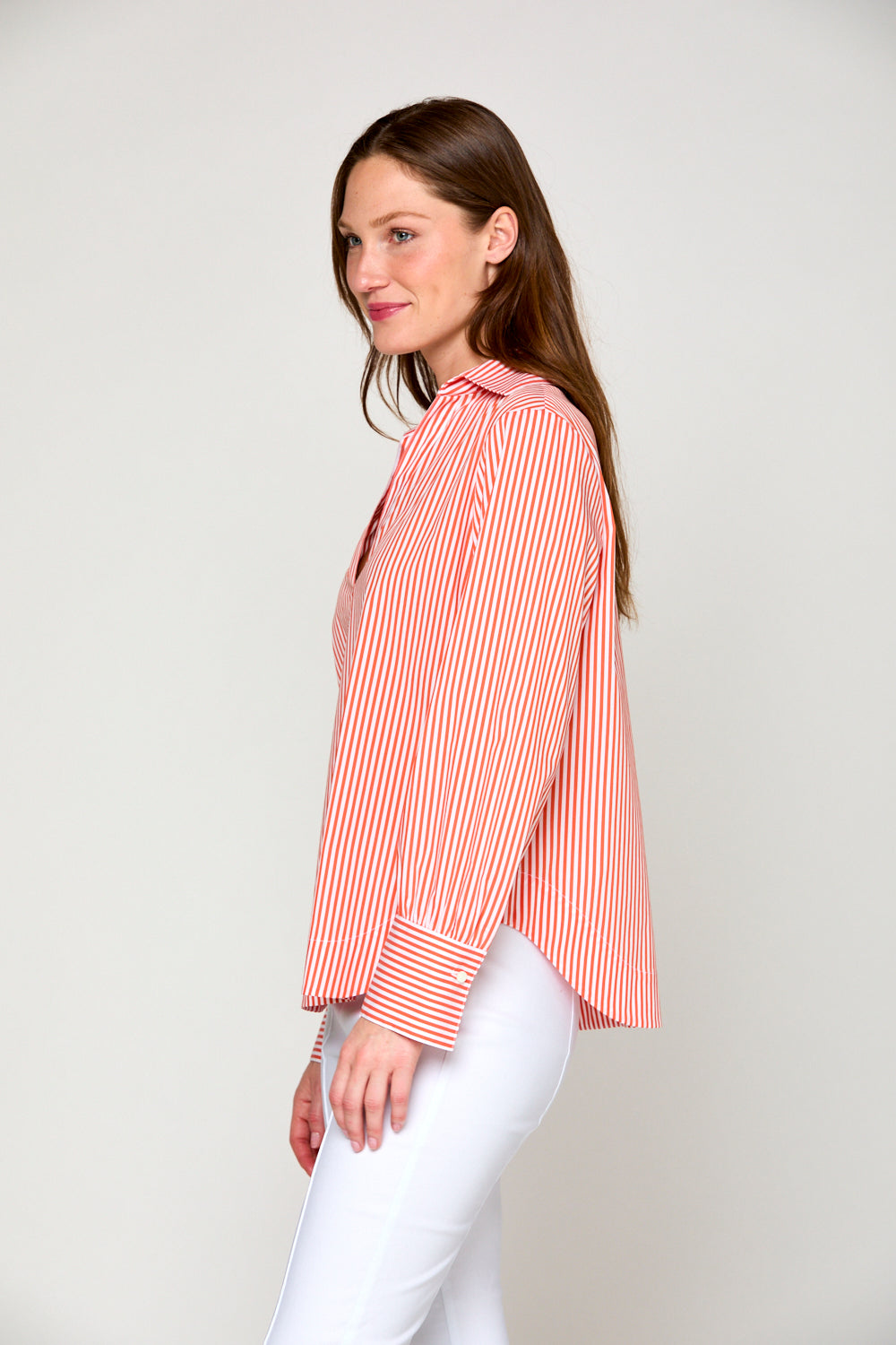 Woman in orange and white striped top