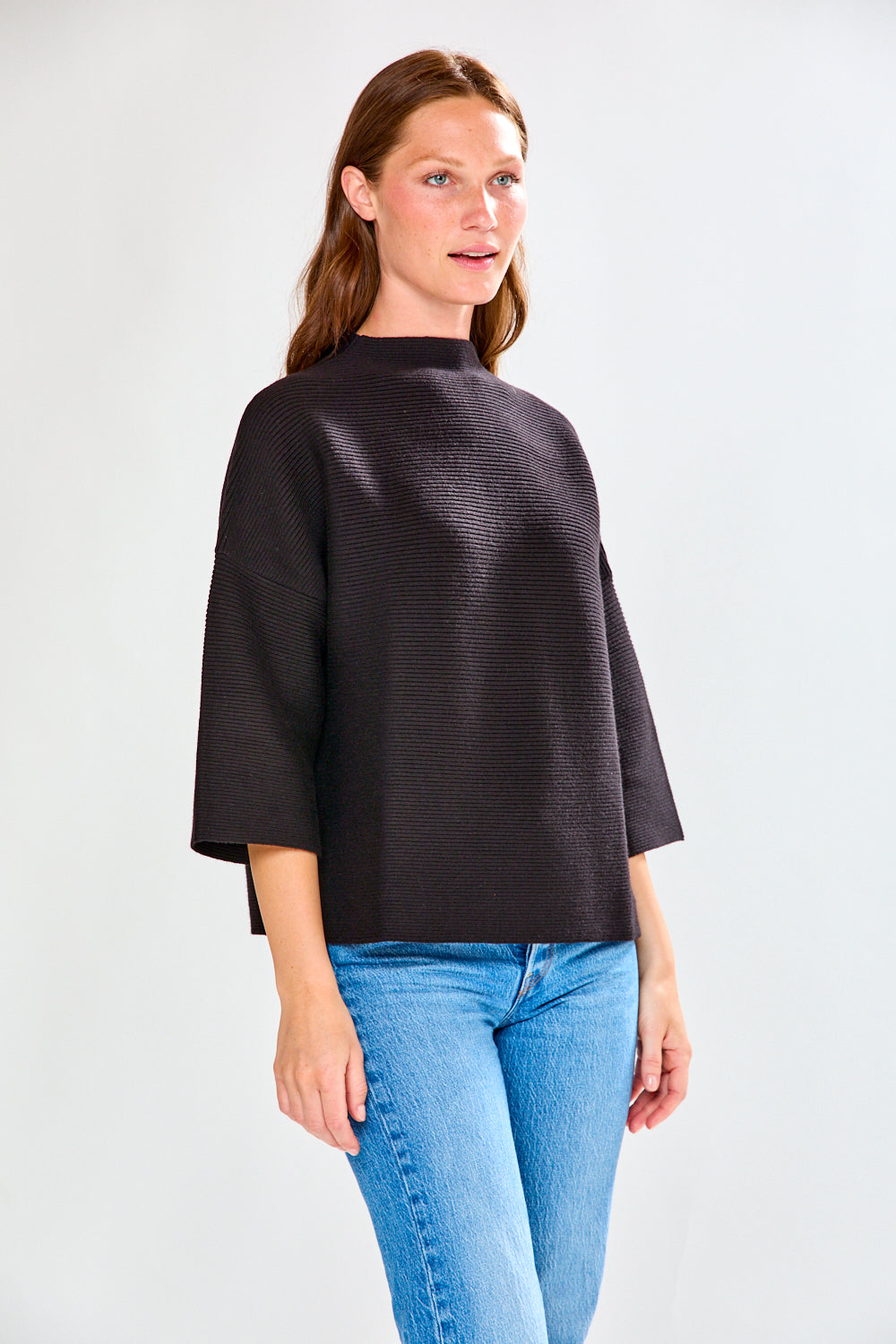 Woman in black ribbed sweater