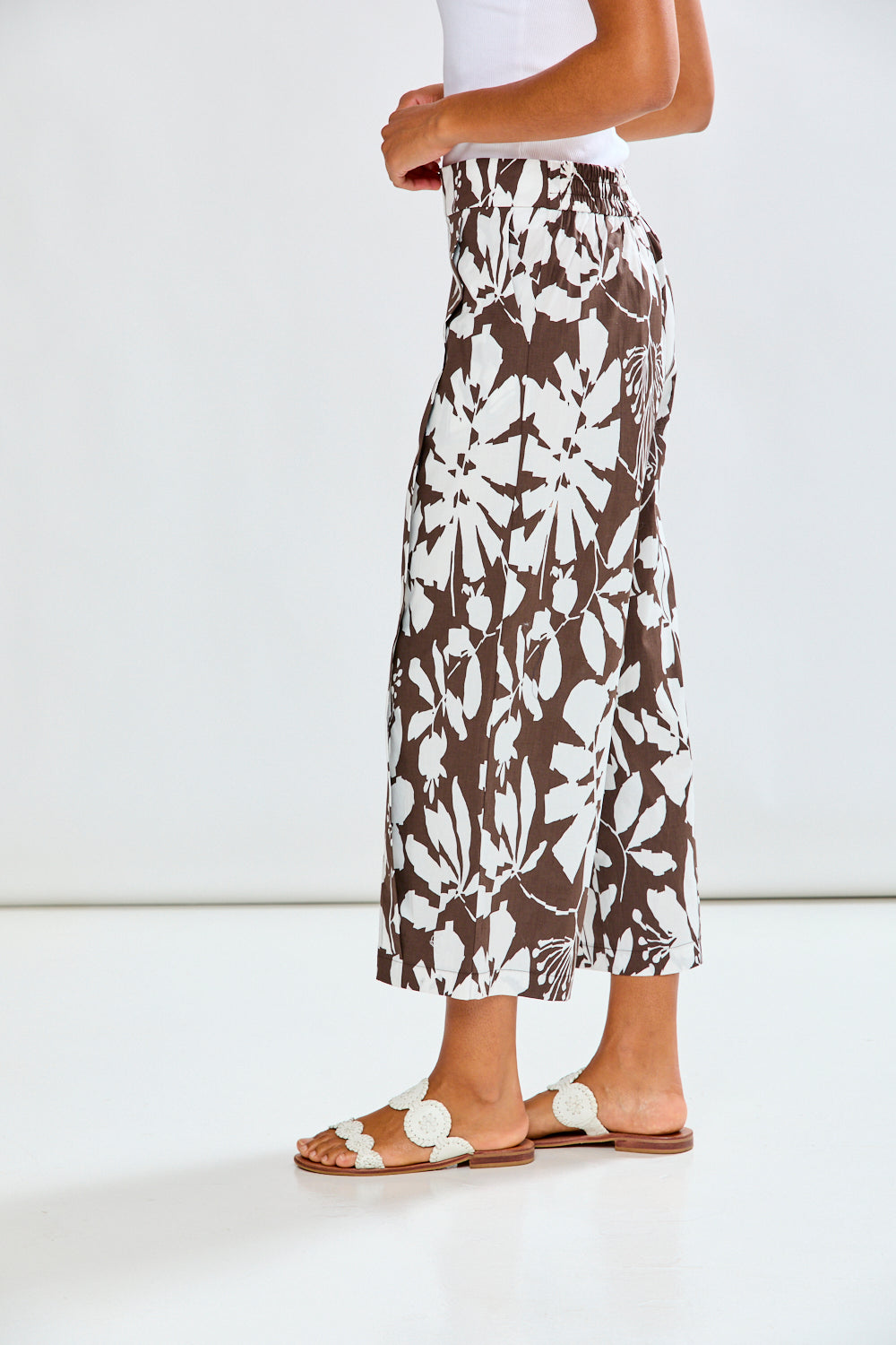 Woman wearing patterned pants with a white background