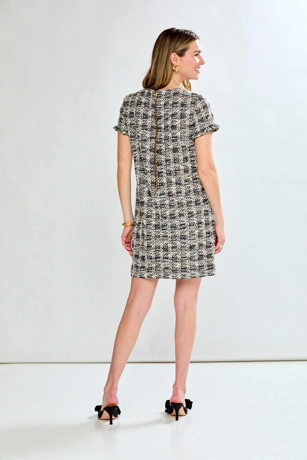 Woman wearing a patterned dress on a white background