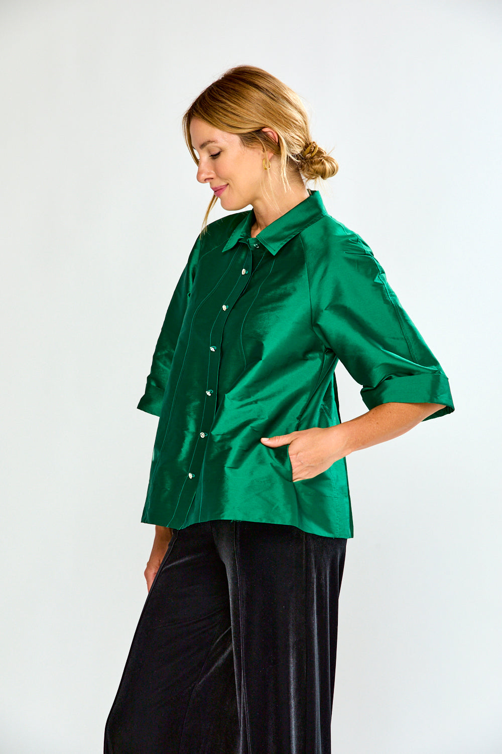 Woman wearing a green shirt with a collar on a white background