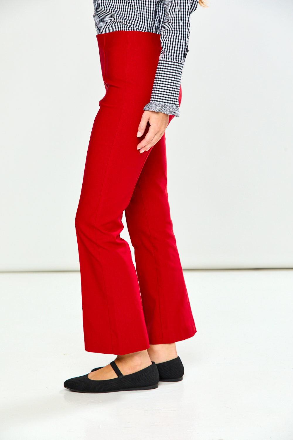 The Mallory Pant - Red shown as sophisticated red women's pants styled with a checked blouse and black Mary Jane shoes.