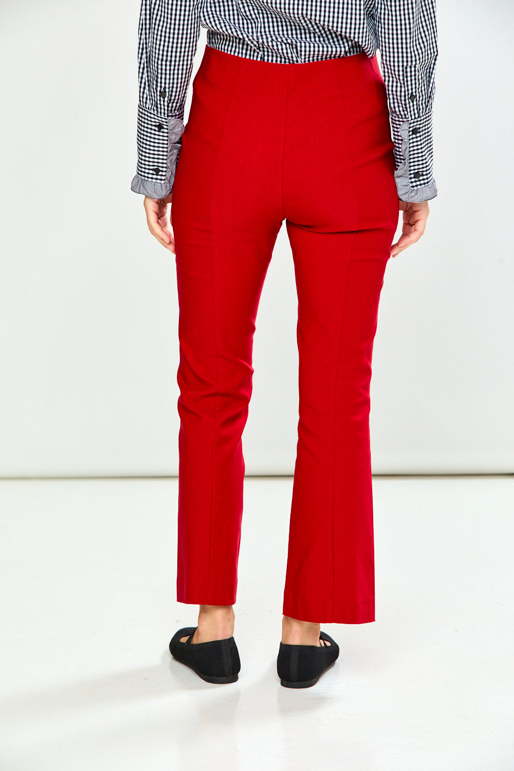The Mallory Pant - Red shown from the back with a slim leg fit styled with a checked shirt and black loafers for a chic timeless look