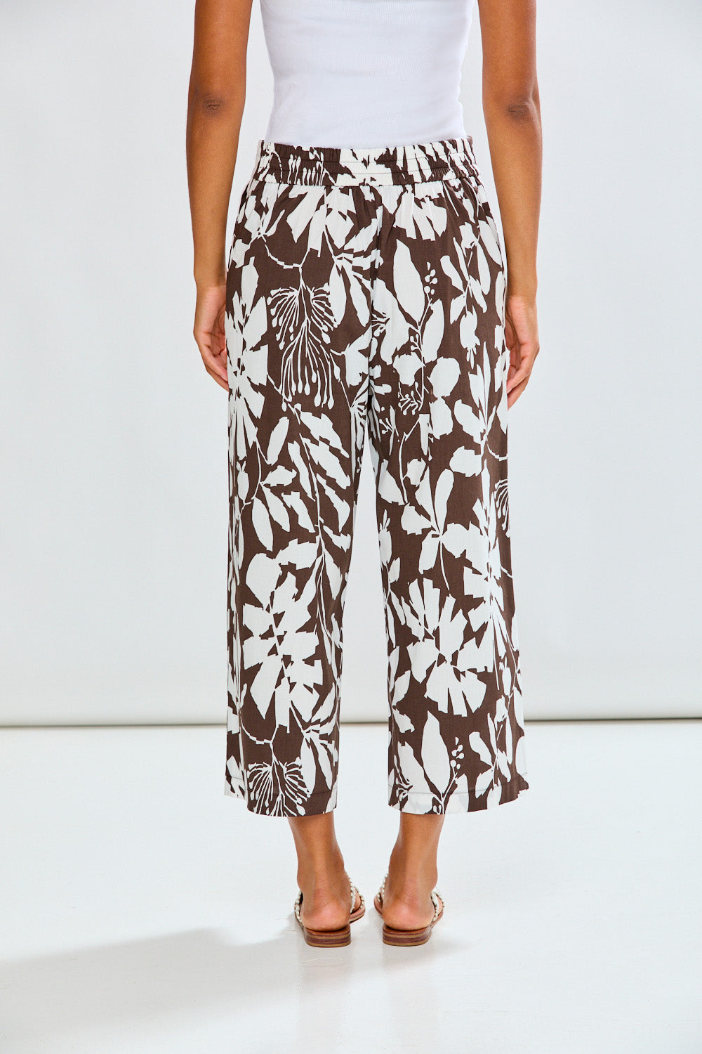 Woman wearing patterned pants with a white background