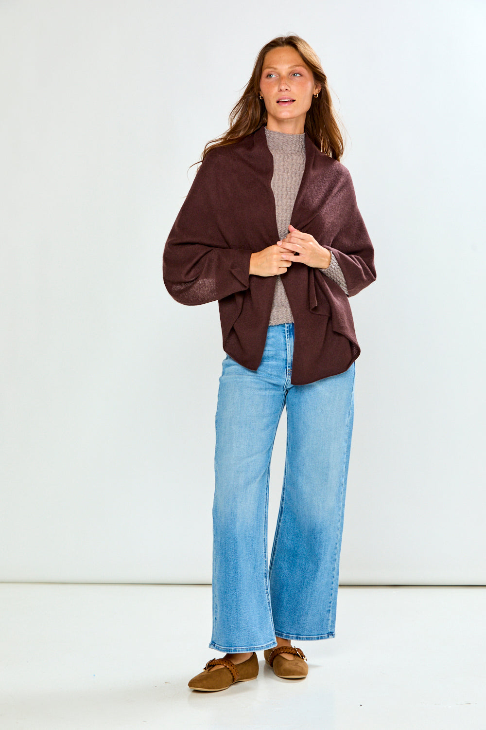 The Classic Cashmere Scarf in rich burgundy styled as a sophisticated wrap over a neutral sweater with wide leg jeans and loafers