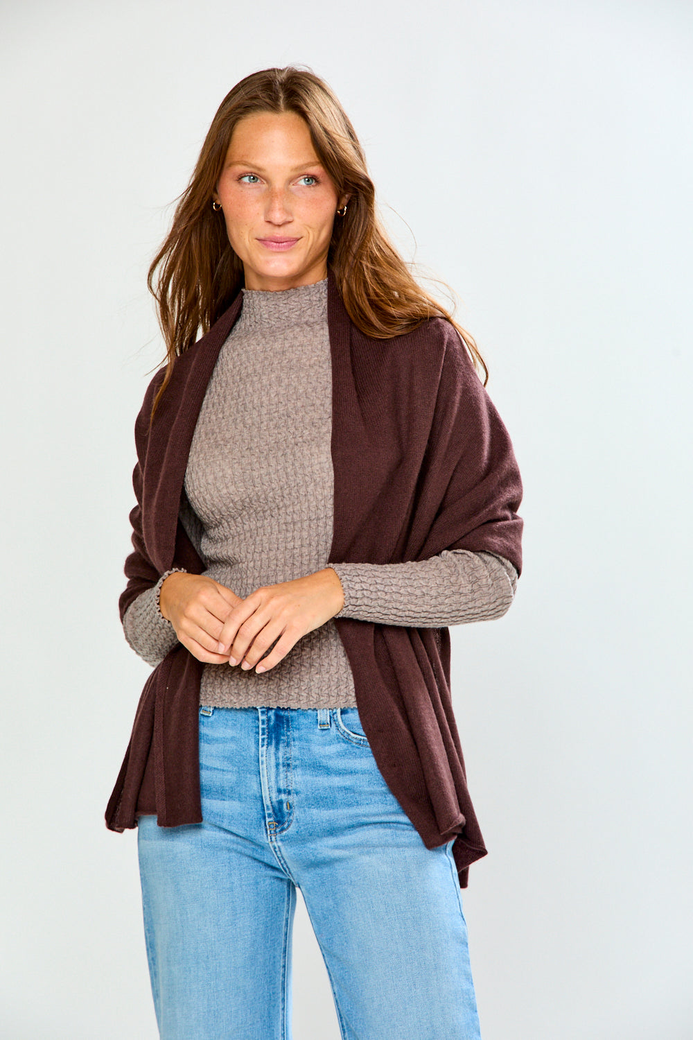 The Classic Cashmere Scarf styled as a burgundy wrap over a textured sweater with jeans for a chic timeless womens accessories look