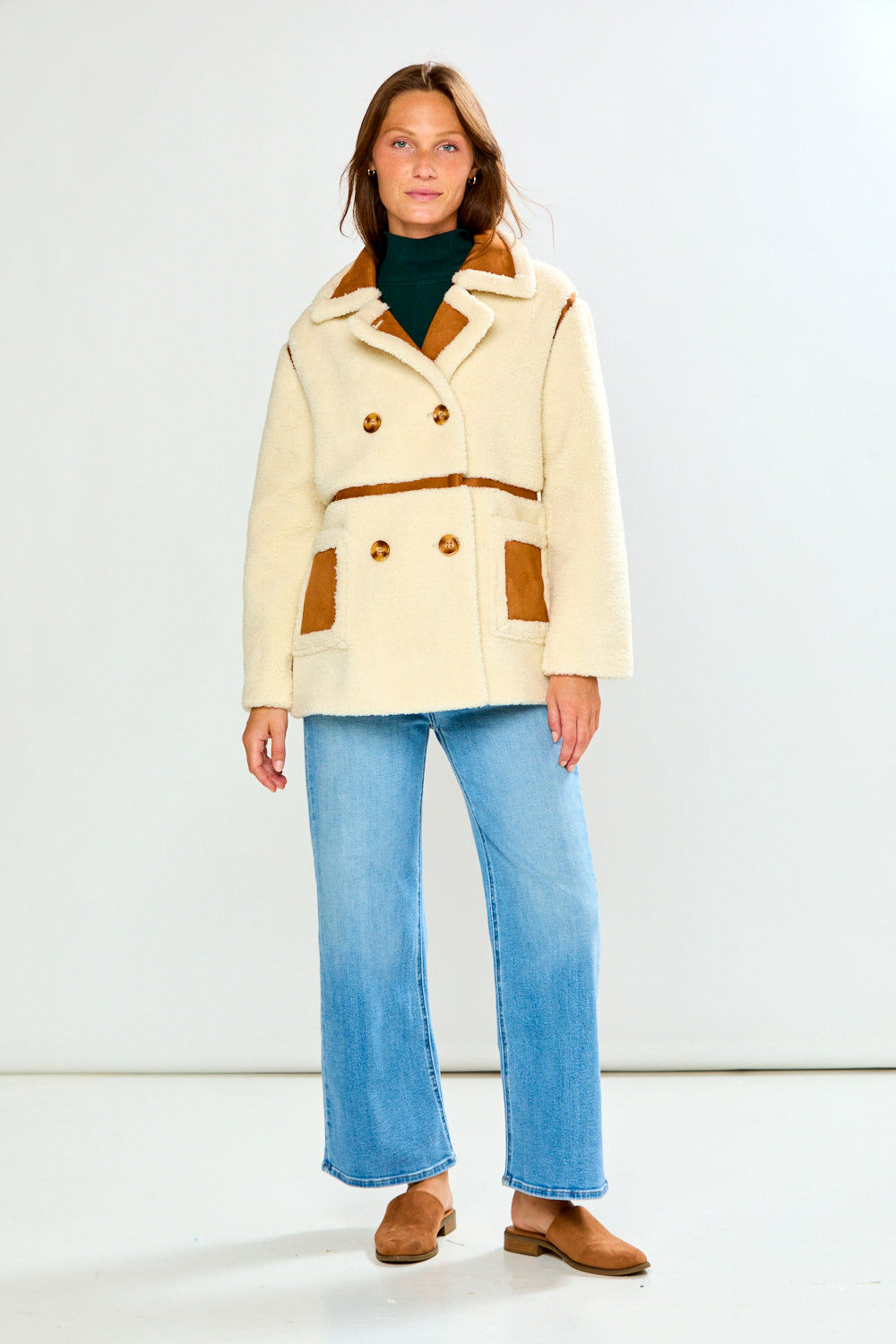 The Phoenix Coat - Tan styled with wide leg jeans and brown shoes for a chic timeless women's jackets look in a studio setting