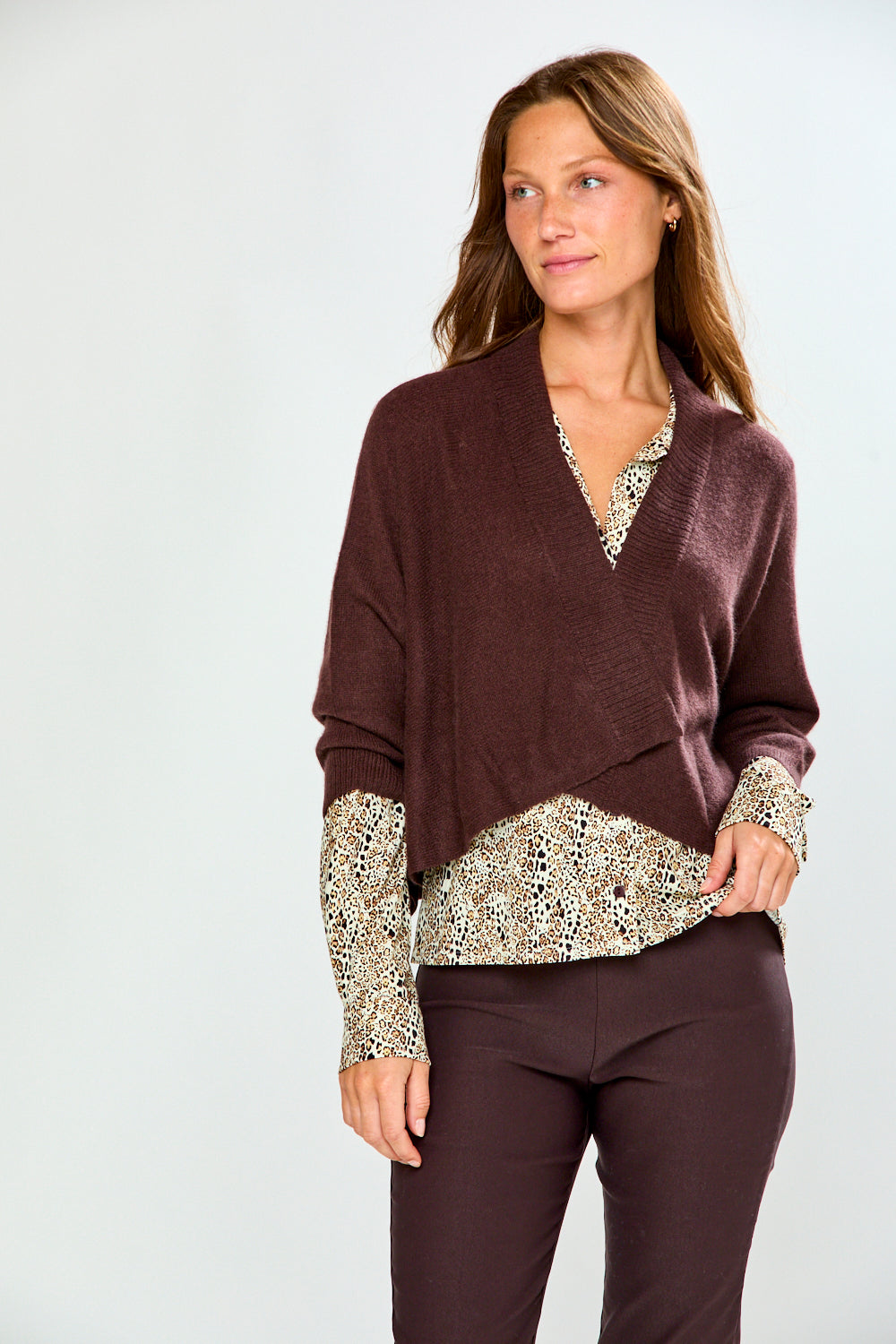 The Shrug with Kimono Sleeves in Toffee 100% cashmere sweater styled over a patterned blouse with tailored pants for a chic sophisticated timeless look