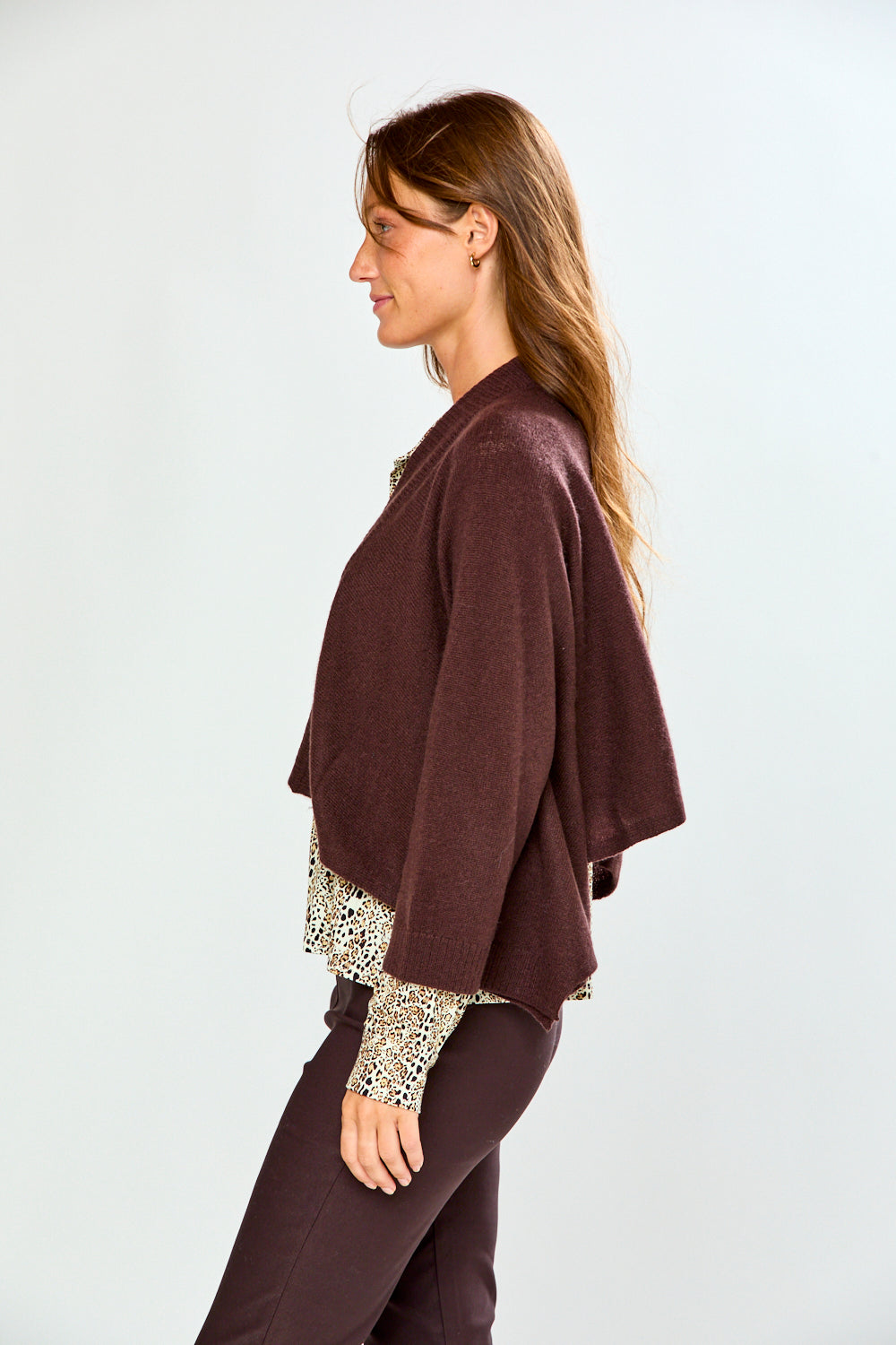 The Shrug with Kimono Sleeves in Toffee shown on a woman as a relaxed 100% cashmere womens sweater with wide draped sleeves over a patterned blouse