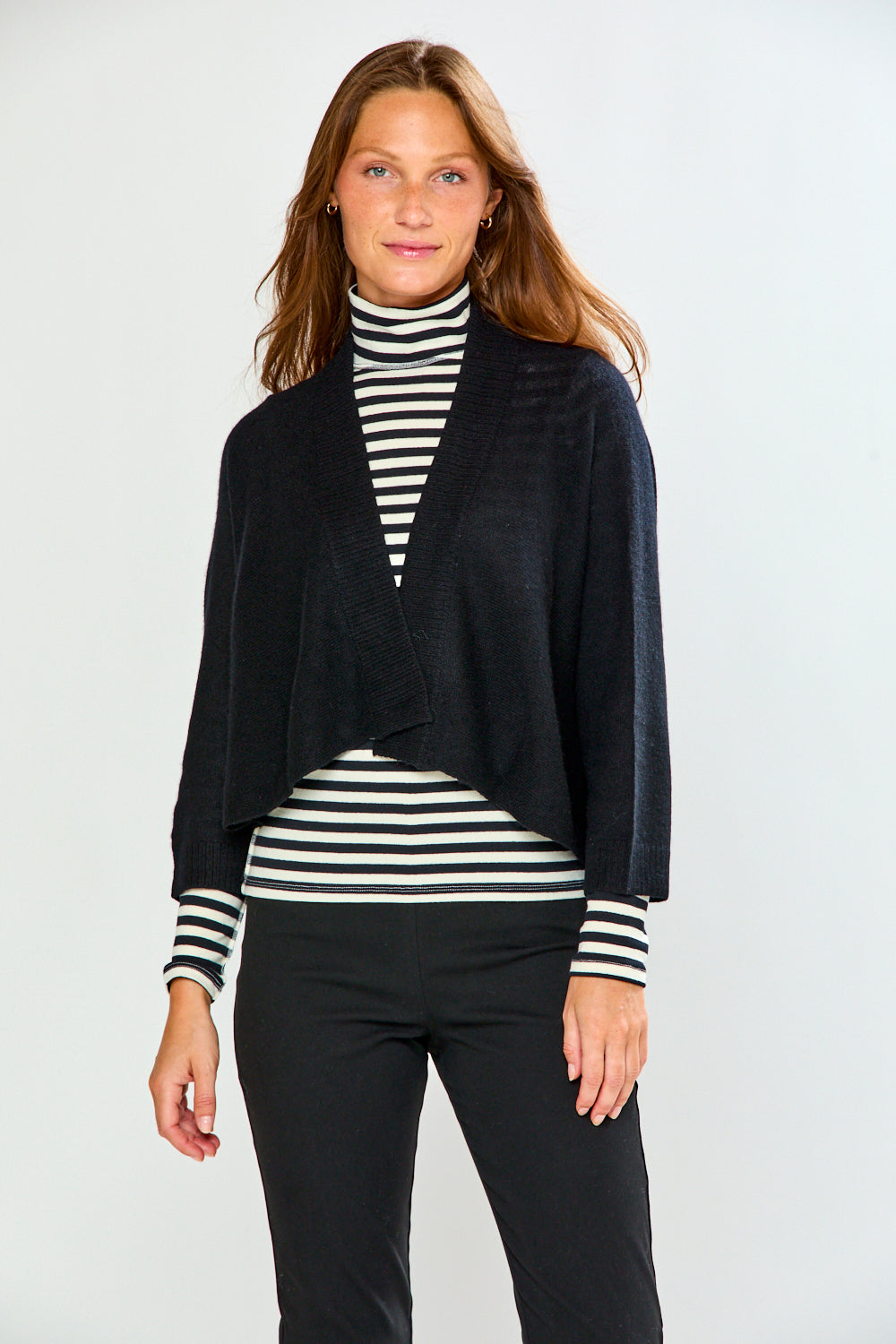 The Shrug with Kimono Sleeves in Black styled over a striped top with black pants for a chic timeless women's sweater look