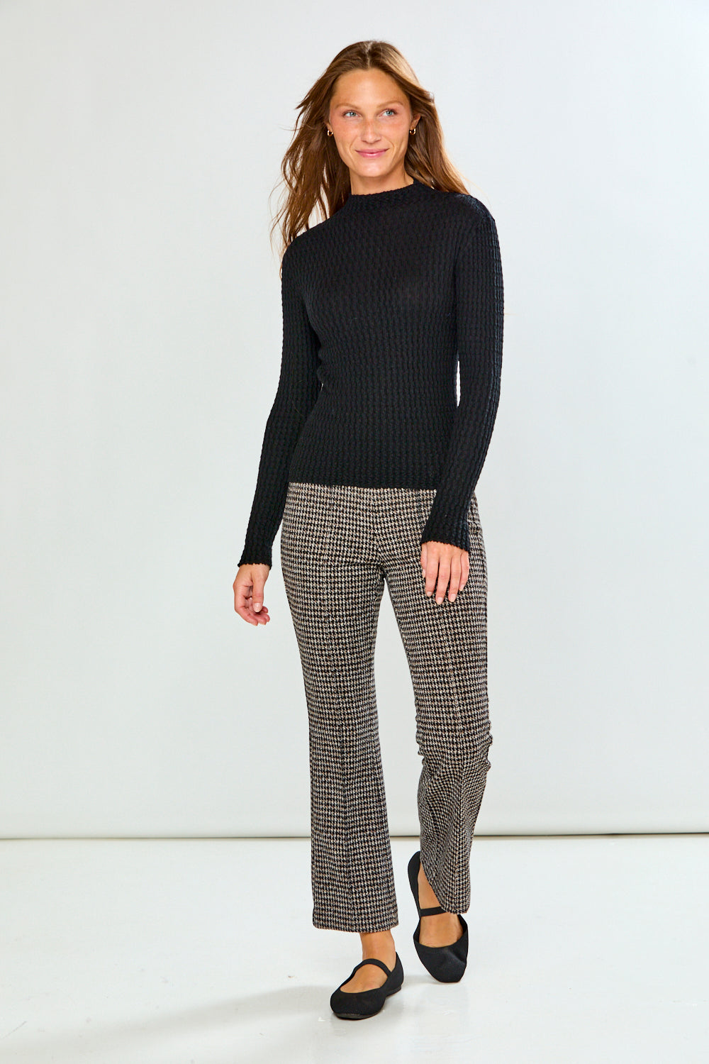 Woman in black long sleeve textured top