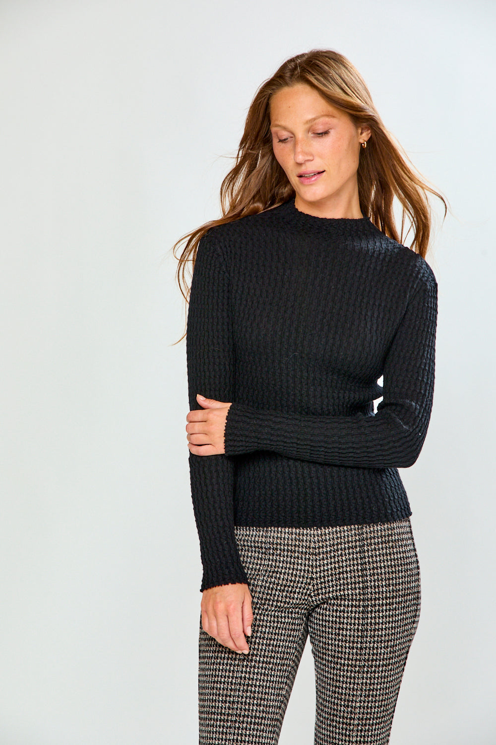 Woman in black long sleeve textured top